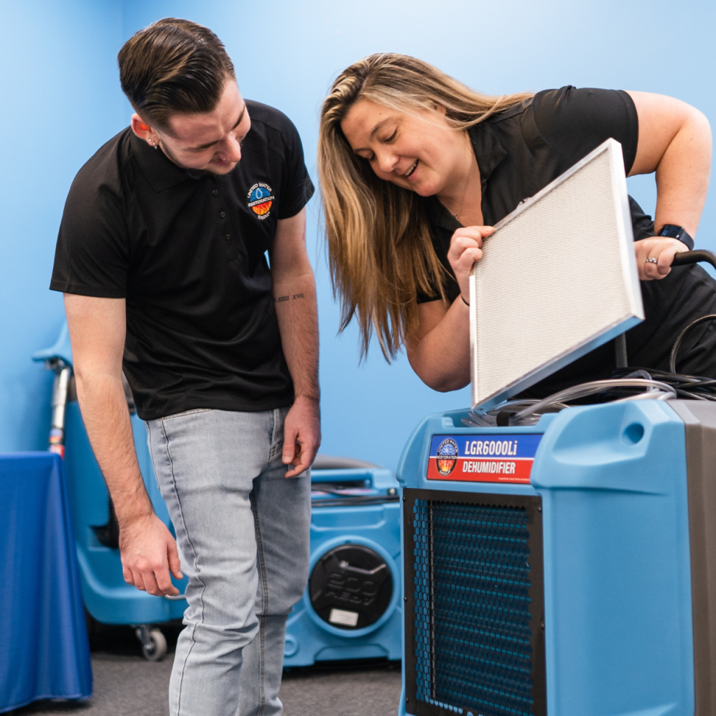 united-water-restoration-group-of-lakeland-staff-changing-dehumidifer-filter united-water-restoration-group-of-lakeland-staff-changing-dehumidifer-filter